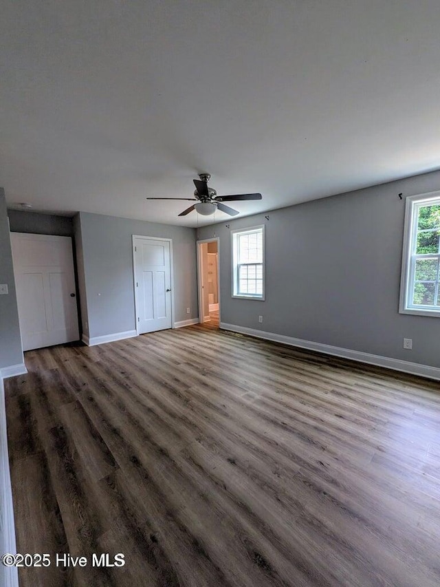 353 N Stephens St, Southern Pines, NC 28387 - unfurnished bedroom featuring multiple windows, baseboards, and wood finished floors