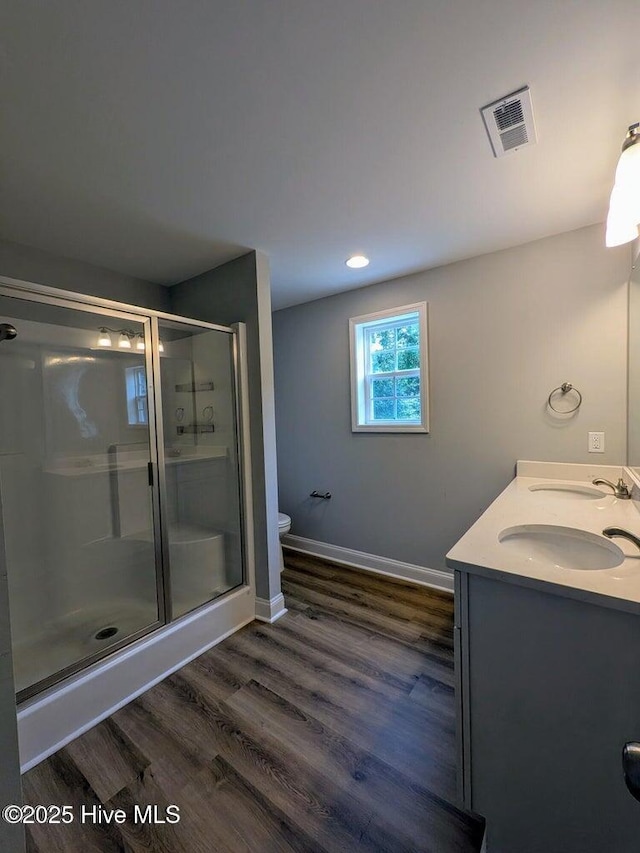 353 N Stephens St, Southern Pines, NC 28387 - bathroom featuring toilet, a stall shower, wood finished floors, baseboards, and double vanity