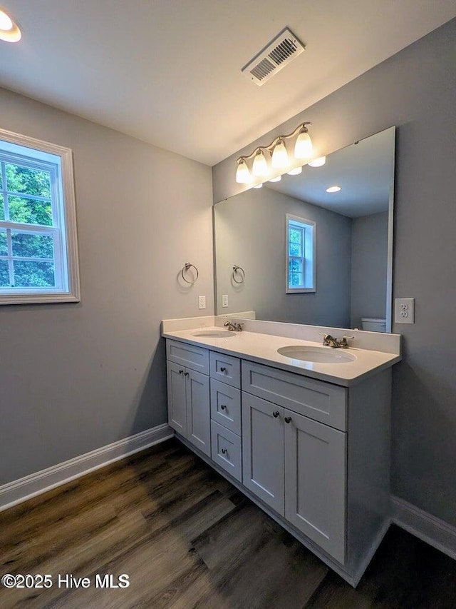 353 N Stephens St, Southern Pines, NC 28387 - full bath featuring double vanity, healthy amount of natural light, wood finished floors, and baseboards