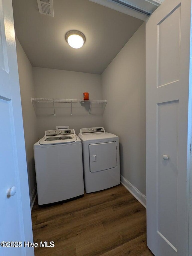 353 N Stephens St, Southern Pines, NC 28387 - laundry room featuring washer and clothes dryer, dark wood-type flooring, and baseboards