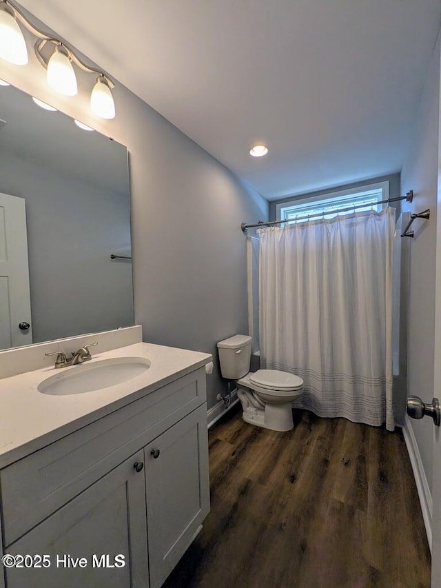 353 N Stephens St, Southern Pines, NC 28387 - full bath featuring toilet, vanity, wood finished floors, a shower with curtain, and baseboards