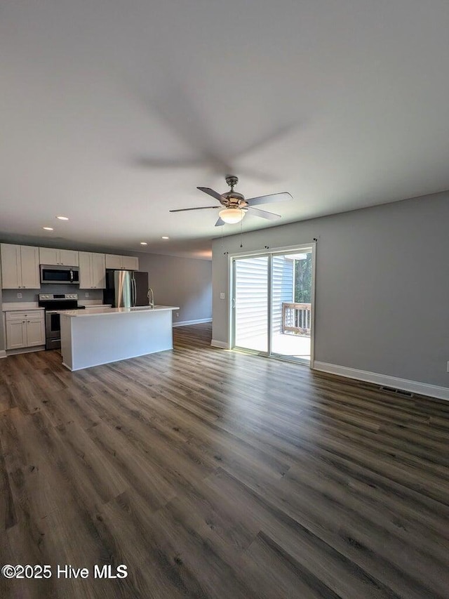 353 N Stephens St, Southern Pines, NC 28387 - unfurnished living room with recessed lighting, baseboards, dark wood-type flooring, and a ceiling fan