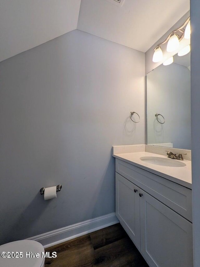 353 N Stephens St, Southern Pines, NC 28387 - half bath with vanity, wood finished floors, toilet, and baseboards