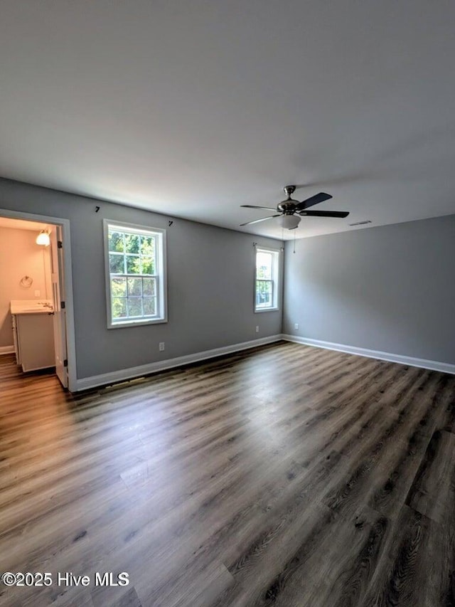 353 N Stephens St, Southern Pines, NC 28387 - unfurnished room with baseboards, wood finished floors, and a ceiling fan