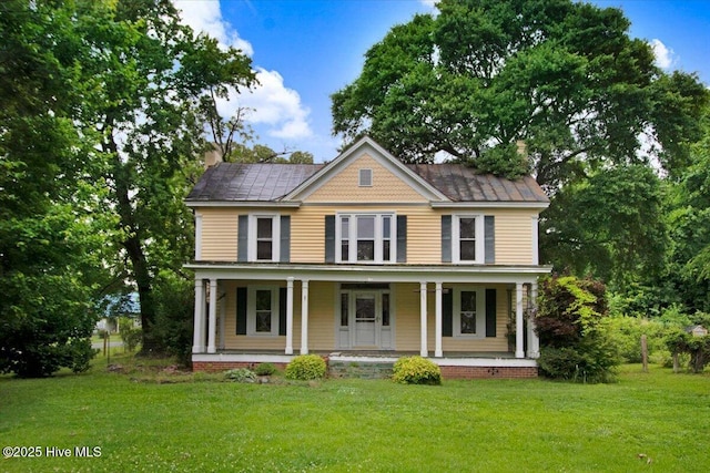 105 W Wayne St, Fremont, NC 27830 - view of front facade featuring a front lawn, a chimney, and covered porch