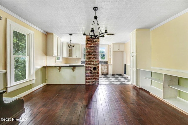 105 W Wayne St, Fremont, NC 27830 - kitchen featuring a chandelier, cream cabinets, healthy amount of natural light, a peninsula, and ornamental molding