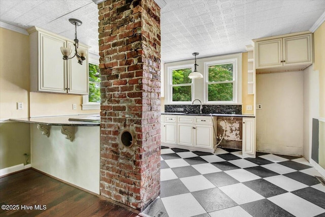 105 W Wayne St, Fremont, NC 27830 - kitchen with cream cabinets, an ornate ceiling, healthy amount of natural light, dark countertops, and pendant lighting