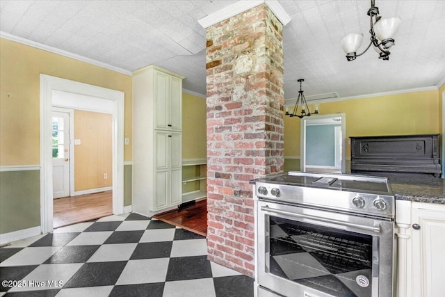105 W Wayne St, Fremont, NC 27830 - kitchen with stainless steel electric stove, dark flooring, a chandelier, cream cabinetry, and crown molding