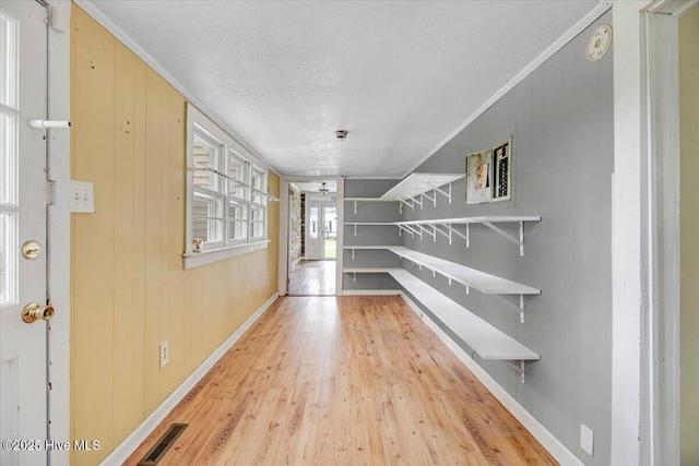 105 W Wayne St, Fremont, NC 27830 - hallway featuring wood finished floors, ornamental molding, a textured ceiling, and wood walls