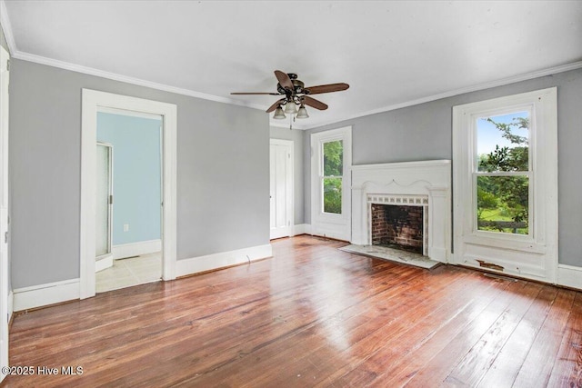 105 W Wayne St, Fremont, NC 27830 - unfurnished living room with wood-type flooring, a fireplace with flush hearth, a ceiling fan, and crown molding