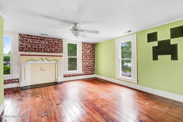 105 W Wayne St, Fremont, NC 27830 - unfurnished living room featuring a textured ceiling, wood-type flooring, ceiling fan, and a fireplace