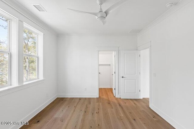 3404 Eagle Crest Dr SW, Supply, NC 28462 - unfurnished bedroom featuring light wood-style floors, a walk in closet, ornamental molding, a closet, and a ceiling fan