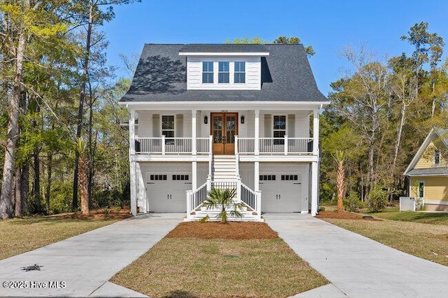 3404 Eagle Crest Dr SW, Supply, NC 28462 - view of front facade featuring stairway, a porch, concrete driveway, french doors, and an attached garage