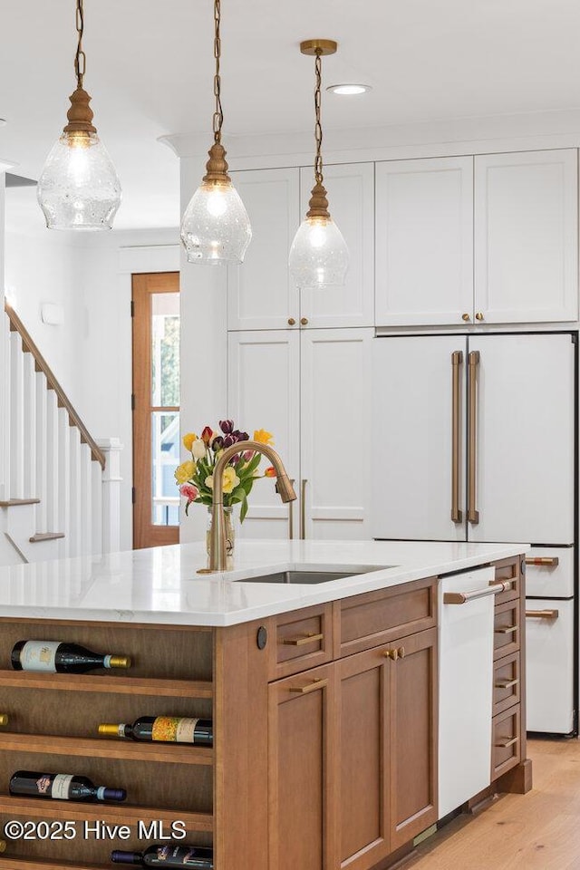 3404 Eagle Crest Dr SW, Supply, NC 28462 - kitchen featuring white dishwasher, pendant lighting, light wood finished floors, brown cabinetry, and recessed lighting