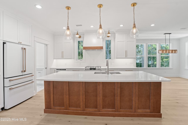 3404 Eagle Crest Dr SW, Supply, NC 28462 - kitchen with high end white refrigerator, custom range hood, light countertops, light wood-style floors, and recessed lighting