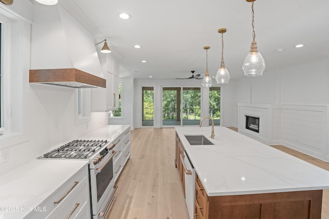 3404 Eagle Crest Dr SW, Supply, NC 28462 - kitchen featuring white appliances, custom range hood, light wood-type flooring, a large island, and a ceiling fan