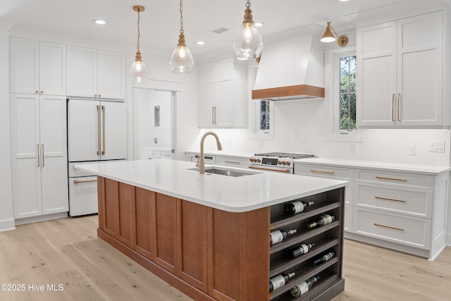 3404 Eagle Crest Dr SW, Supply, NC 28462 - kitchen featuring high end appliances, custom range hood, light wood-style floors, white cabinetry, and recessed lighting