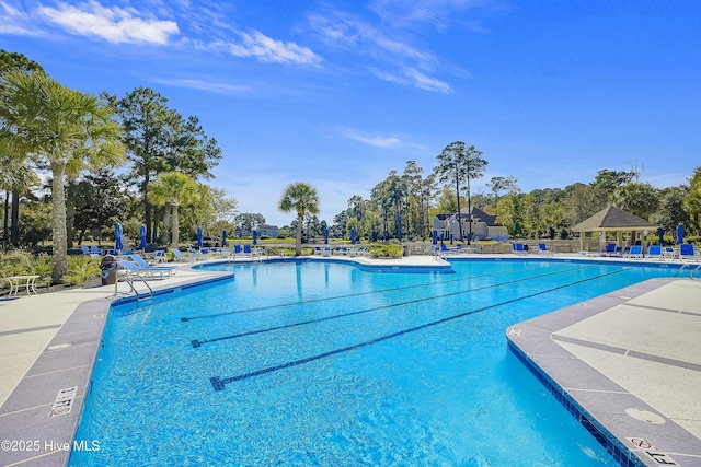6857 Beckman Cir SW Unit 55, Ocean Isle Beach, NC 28469 - community pool with a patio, a gazebo, and view of wooded area