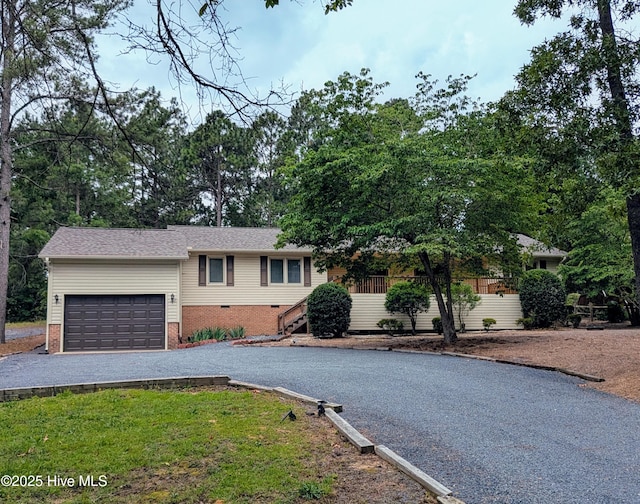 102 Thistle Ln, West End, NC 27376 - view of front of property featuring an attached garage, asphalt driveway, and brick siding