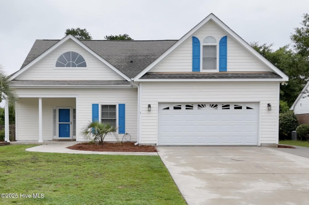 1 Bay Dr, Sneads Ferry, NC 28460 - view of front of property with driveway, a front lawn, a shingled roof, and a garage
