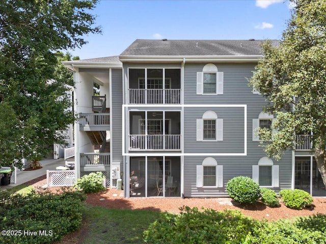 145 Royal Poste Rd # 3110, Sunset Beach, NC 28468 - rear view of house with a shingled roof and a sunroom