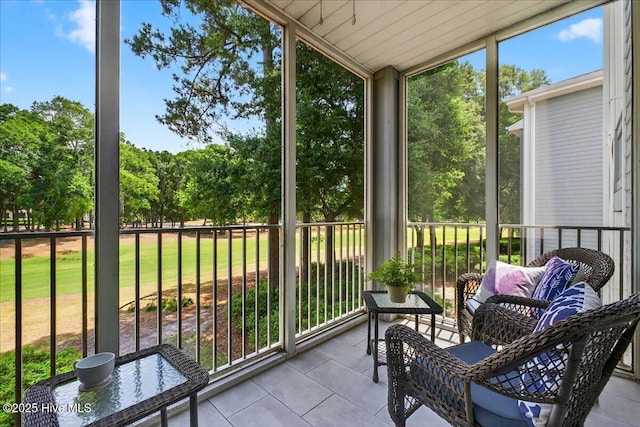 145 Royal Poste Rd # 3110, Sunset Beach, NC 28468 - sunroom featuring lofted ceiling and view of scattered trees