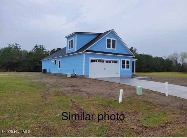 459 Fowler Manning Rd, Richlands, NC 28574 - view of property exterior with concrete driveway, a yard, and a garage