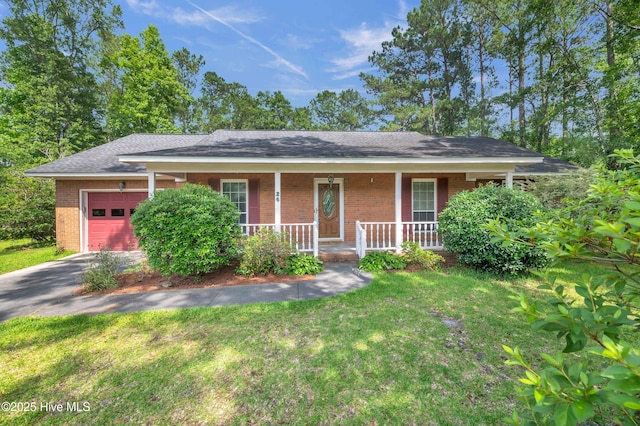 26 Combine Ln SE, Leland, NC 28451 - single story home with brick siding, a garage, asphalt driveway, covered porch, and a front lawn