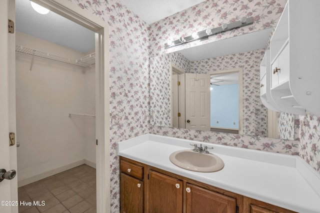 26 Combine Ln SE, Leland, NC 28451 - bathroom with wallpapered walls, vanity, and a walk in closet