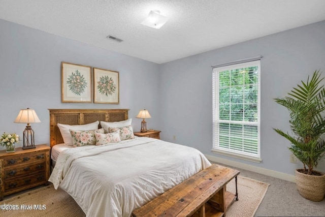 26 Combine Ln SE, Leland, NC 28451 - bedroom featuring light colored carpet and a textured ceiling