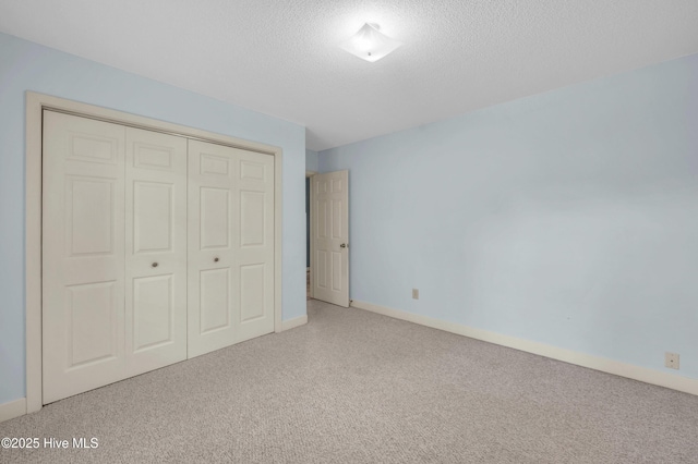 26 Combine Ln SE, Leland, NC 28451 - unfurnished bedroom with carpet, a textured ceiling, and a closet
