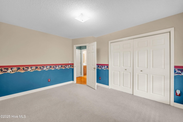 26 Combine Ln SE, Leland, NC 28451 - unfurnished bedroom with light colored carpet, a textured ceiling, and a closet