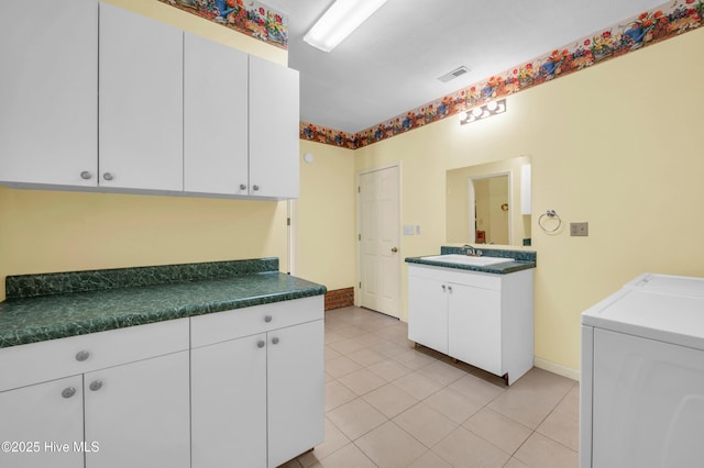 26 Combine Ln SE, Leland, NC 28451 - washroom featuring cabinet space, separate washer and dryer, and light tile patterned flooring