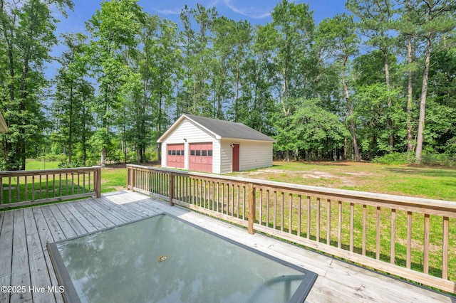 26 Combine Ln SE, Leland, NC 28451 - wooden deck featuring a detached garage, an outdoor structure, a lawn, and view of wooded area