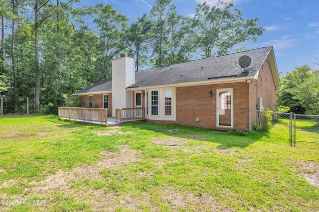 26 Combine Ln SE, Leland, NC 28451 - back of house featuring brick siding, a chimney, a wooden deck, a gate, and roof with shingles