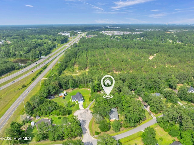 26 Combine Ln SE, Leland, NC 28451 - aerial view of property and surrounding area featuring a heavily wooded area