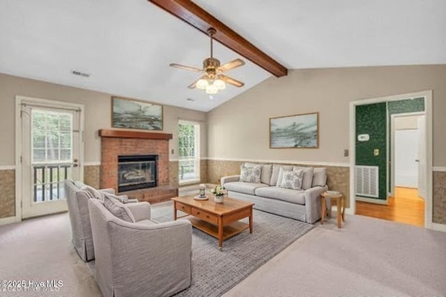 26 Combine Ln SE, Leland, NC 28451 - living area featuring wainscoting, carpet flooring, ceiling fan, and a fireplace