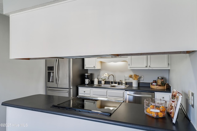 2418 Bradfield Ct, Wilmington, NC 28411 - kitchen featuring appliances with stainless steel finishes, dark countertops, and white cabinets