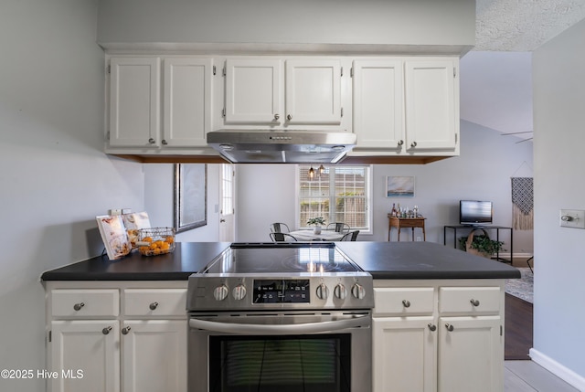 2418 Bradfield Ct, Wilmington, NC 28411 - kitchen with electric stove, under cabinet range hood, dark countertops, and white cabinetry