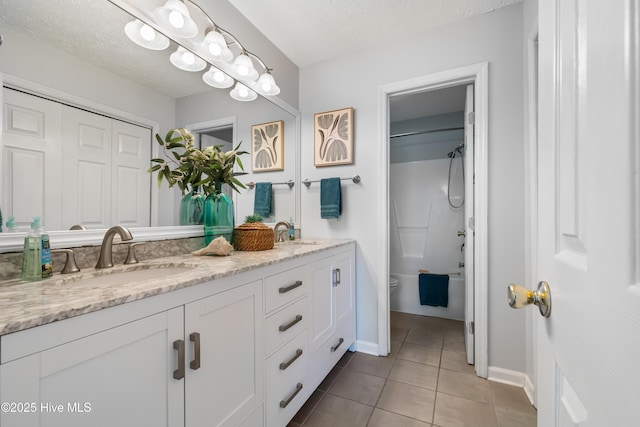 2418 Bradfield Ct, Wilmington, NC 28411 - full bath featuring double vanity, tile patterned floors, bathtub / shower combination, and a textured ceiling