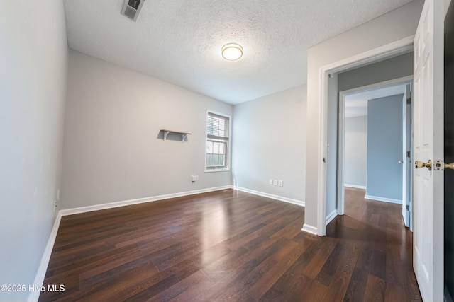 2418 Bradfield Ct, Wilmington, NC 28411 - unfurnished room with dark wood finished floors and a textured ceiling