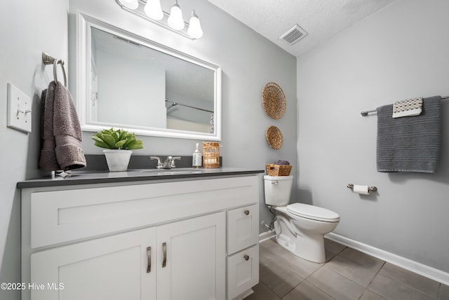 2418 Bradfield Ct, Wilmington, NC 28411 - full bath with vanity, a textured ceiling, and tile patterned floors
