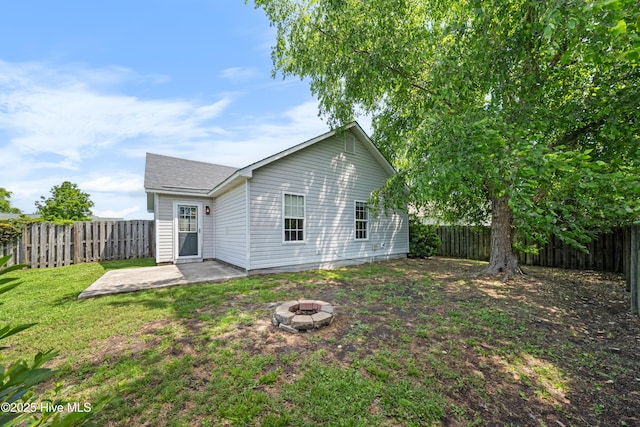 2418 Bradfield Ct, Wilmington, NC 28411 - back of house with a fire pit, a fenced backyard, and a patio area