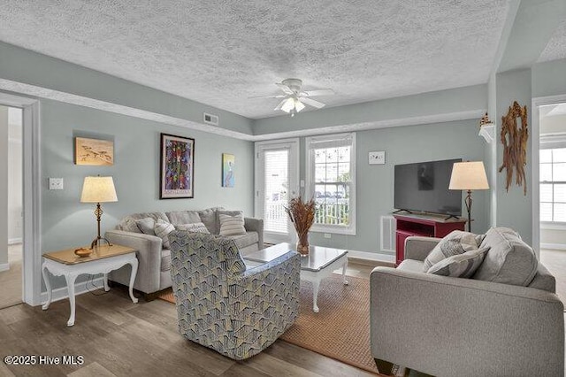 1701 Bowfin Ln Unit B, Carolina Beach, NC 28428 - living area featuring a ceiling fan, wood finished floors, healthy amount of natural light, and a textured ceiling