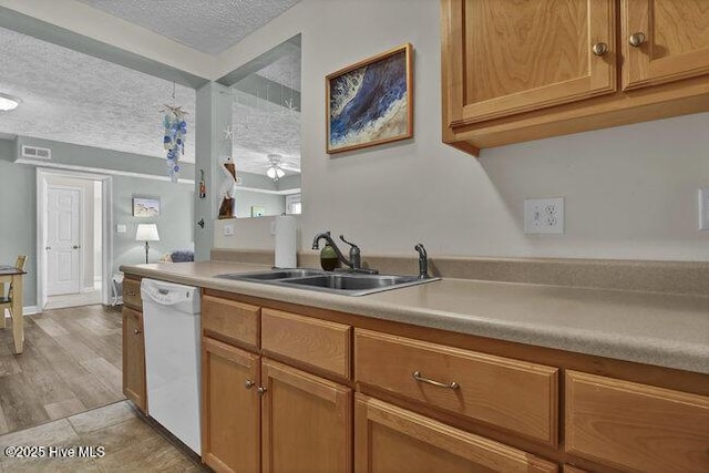 1701 Bowfin Ln Unit B, Carolina Beach, NC 28428 - kitchen featuring dishwasher, a textured ceiling, light countertops, ceiling fan, and brown cabinetry