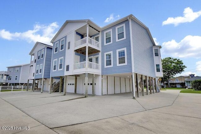 1701 Bowfin Ln Unit B, Carolina Beach, NC 28428 - view of building exterior with a carport, concrete driveway, and a garage