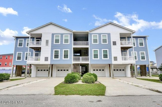 1701 Bowfin Ln Unit B, Carolina Beach, NC 28428 - coastal inspired home featuring an attached garage and driveway