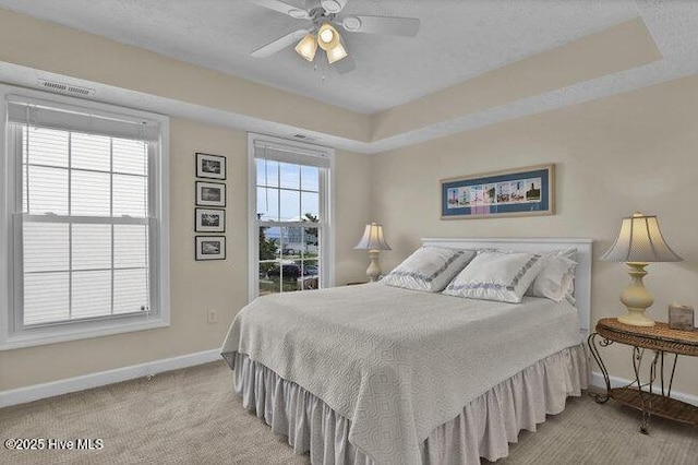 1701 Bowfin Ln Unit B, Carolina Beach, NC 28428 - bedroom featuring a raised ceiling, a ceiling fan, and carpet