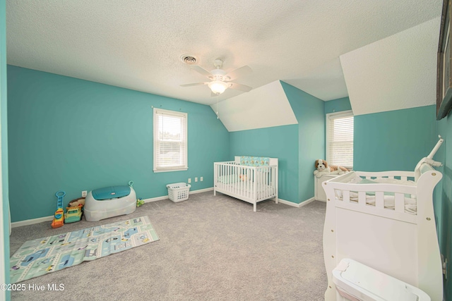 113 Lakehurst Dr, Dudley, NC 28333 - bedroom with multiple windows, a crib, carpet flooring, a textured ceiling, and ceiling fan