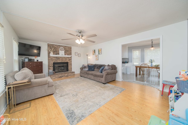 113 Lakehurst Dr, Dudley, NC 28333 - living room featuring wood finished floors, a ceiling fan, and a brick fireplace